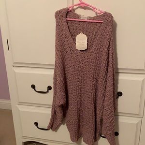 A long pink knitted sweater